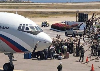 A picture of a Russian-flagged aircraft posted on social media showed men in uniform clustered around it on the tarmac.