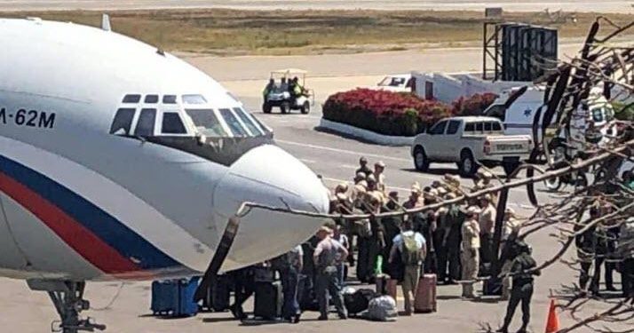 A picture of a Russian-flagged aircraft posted on social media showed men in uniform clustered around it on the tarmac.