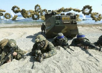 In this March 12, 2016, file photo, Marines of the U.S., left, and South Korea, wearing blue headbands on their helmets, take positions after landing on a beach during the joint military combined amphibious exercise, called Ssangyong, part of the Key Resolve and Foal Eagle military exercises, in Pohang, South Korea. South Korea and the U.S. say they've decided to end their springtime military drills to back diplomacy with North Korea. (AP)