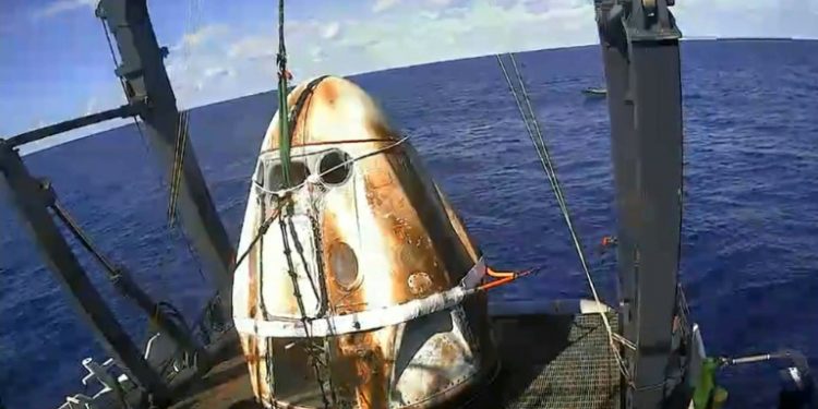 This still image taken from NASA TV shows SpaceX's Crew Dragon spacecraft safely aboard the company's recovery vessel following splashdown March 8, 2019 (AFP)