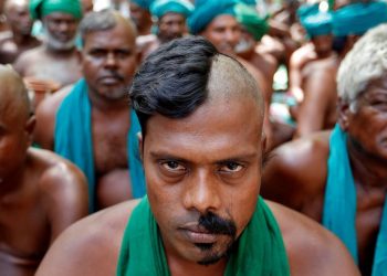 Farmers from the southern state of Tamil Nadu pose half shaved during a protest demanding a drought-relief package from the federal government, in New Delh (Reuters)