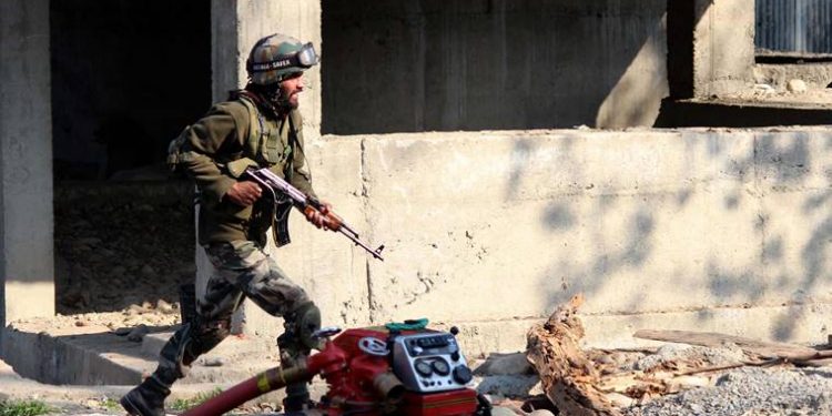 An army personnal walk during a gun battle between suspected militants and security forces in shopian, south of SrinagarExpress Photo by Shuaib Masoodi 01-04-2018 (PTI)