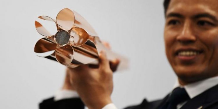 The shiny rose-gold torch, which is 71 centimetres (28 inches) long and weighs 1.2 kilograms (2 pounds 10 ounces). (Image: AFP)
