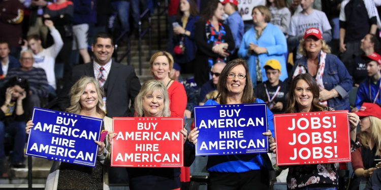 People wait for President Donald Trump to speak at a rally in Grand Rapids, Mich., Thursday, March 28, 2019. (AP Photo/Manuel Balce Ceneta)