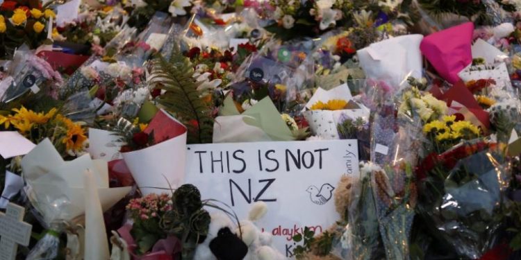 A poster at the makeshift memorial for victims condemning the attack on the mosques in Christchurch