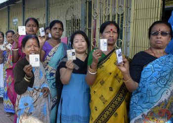 Cooch Behar: People show their voter identity cards before casting their votes during the first phase of the general elections, at a polling station in Cooch Behar, West Bengal, Thursday, April 11, 2019. (PTI Photo)