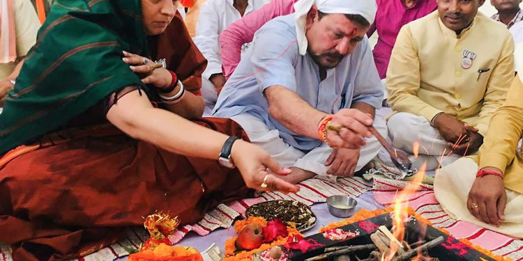 Amethi: Union minister and BJP candidate Smriti Irani along with her husband Zubin Irani performs 'puja' before filing her nomination papers for Amethi Lok Sabha seat, in Amethi, Thursday, April 11, 2019. (PTI Photo)