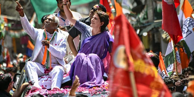 Jhansi: Congress General Secretary Priyanka Gandhi Vadra waves at the supporters during an election campaign roadshow in support of the  party candidate Shiv Sharan Kushwaha (L), in Jhansi, Thursday, April 25, 2019. (Twitter/PTI Photo)  (PTI4_25_2019_000081B)