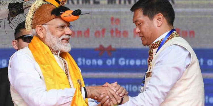 Arunachal Pradesh Chief Minister Pema Khandu shakes hands with PM Modi at the inauguration of several development projects. Itanagar, February 2019. (PTI)