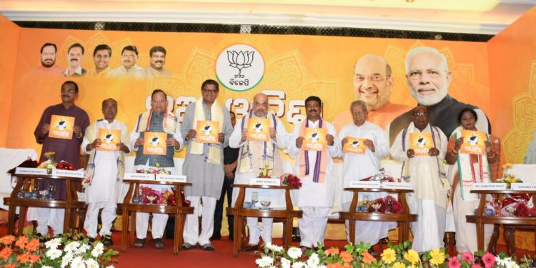 BJP president Amit Shah (C) and other party leaders from Odisha during the launch of the party manifesto in Bhubaneswar, Sunday