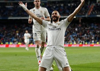 Karim Benzema celebrates after scoring the 89th minute winner for Real Madrid while Gareth Bale (back) joins in against Huesca at Santiago Bernabeu, Monday
