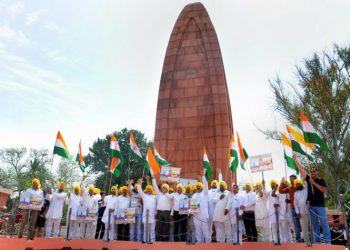 Activists of the All India Anti Terrorist Front (AIATF) hold Indian national flags as they shout patriotic slogans while paying tribute to the martyrs ahead of 100th anniversary of the JallianwalaBagh massacre, at its memorial in Amritsar on Thursday (PTI photo)