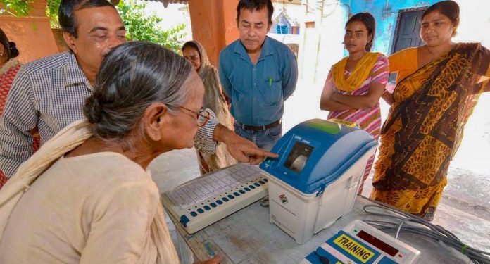 Election officials demonstrate the functioning of EVM and VVPAT for voters (PTI)