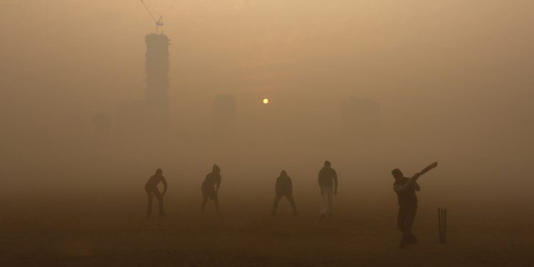 Boys play cricket on a smoggy day in Kolkata. India's growing use of coal power threatens to exacerbate the pollution problem. (REUTERS)