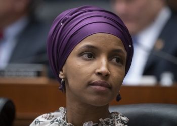 FILE - In this March 6, 2019, file photo, Rep. Ilhan Omar, D-Minn., sits with fellow Democrats on the House Education and Labor Committee during a bill markup, on Capitol Hill in Washington. President Donald Trump is weighing in on the most recent controversy involving Omar, retweeting video edited to suggest that the Minnesota congresswoman was dismissive of the significance of the Sept. 11 attacks. (AP Photo/J. Scott Applewhite, File)