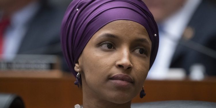 FILE - In this March 6, 2019, file photo, Rep. Ilhan Omar, D-Minn., sits with fellow Democrats on the House Education and Labor Committee during a bill markup, on Capitol Hill in Washington. President Donald Trump is weighing in on the most recent controversy involving Omar, retweeting video edited to suggest that the Minnesota congresswoman was dismissive of the significance of the Sept. 11 attacks. (AP Photo/J. Scott Applewhite, File)