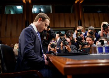FILE- In this April 10, 2018, file photo Facebook CEO Mark Zuckerberg adjusts his tie as he arrives to testify before a joint hearing of the Commerce and Judiciary Committees on Capitol Hill in Washington. Earlier this month Zuckerberg announced a new “privacy-focused vision” for the company to focus on messaging instead of more public sharing, but he stayed mum on overhauling Facebook’s privacy practices in its core business. (AP Photo/Carolyn Kaster, File)