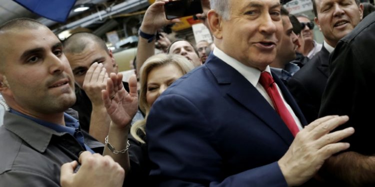 Netanyahu makes his way through Machane Yehuda market in Jerusalem the day before the election (AFP)