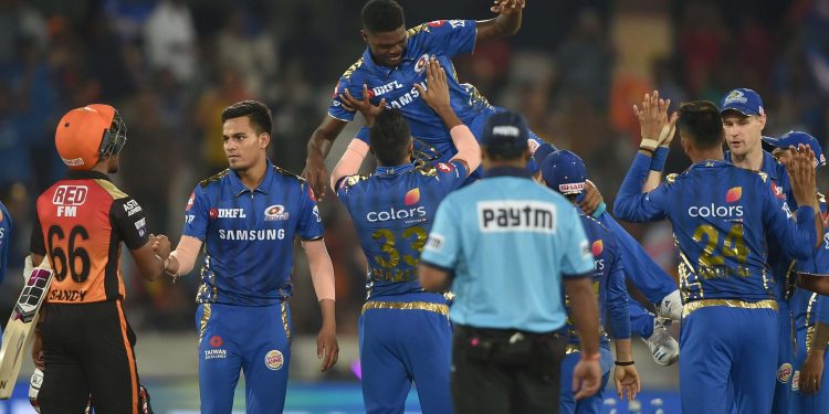 Mumbai Indians players celebrate their victory over Sunrisers Hyderabad by throwing Alzarri Joseph in the air after his six-wicket haul