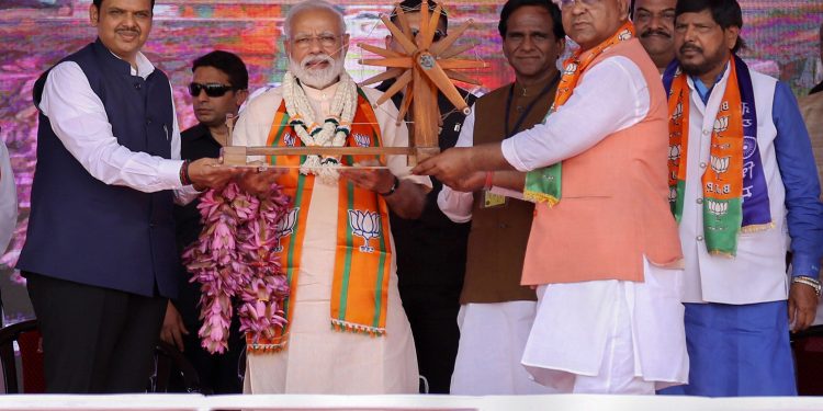 Wardha: Prime Minister Narendra Modi with Chief Minister of Maharashtra Devendra Fadnavis (L) and BJP candidate from Wardha constituency Ramdas Tadas (R), during an election rally, ahead of the Lok Sabha polls, in Wardha, Monday, April 01, 2019. (PTI Photo)(PTI4_1_2019_000066B)
