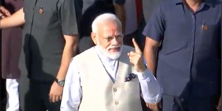 PM Narendra Modi exhibits the indelible ink on his finger after casting his vote in Ahmedabad, Tuesday  Photo courtesy@ BJP Twitter account