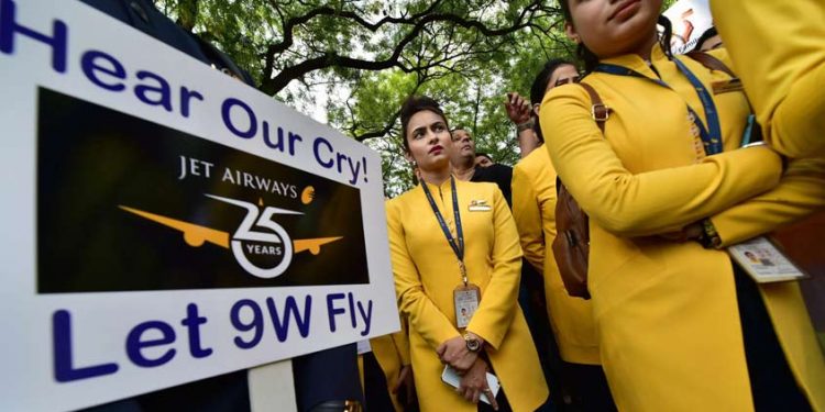 Jet Airways employees hold placards as they gather to make an appeal to save the airline after it announced temporary suspension of flight operations, in New Delhi (PTI photo)
