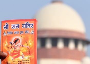 An protester holds a leaflet with the picture of Lord Ram outside the Indian Supreme Court in New Delhi on January 10, 2019, after the hearing in the Ayodhya temple dispute case was further deferred to January 29. - The court is hearing pleas over petitioners demand to build the Ram temple in Ayodhya where a medieval mosque was demolished by Hindu hardliners decades, claiming it was built over an ancient temple dedicated to the birthplace of the deity Ram. It is a deeply polarising project, one that has aggravated deadly fissures between India's Hindu majority and its sizeable Muslim minority. (Photo by Sajjad HUSSAIN / AFP)