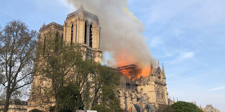 Notre Dame cathedral is burning in Paris, Monday, April 15, 2019. Massive plumes of yellow brown smoke is filling the air above Notre Dame Cathedral and ash is falling on tourists and others around the island that marks the center of Paris. (AP Photo)