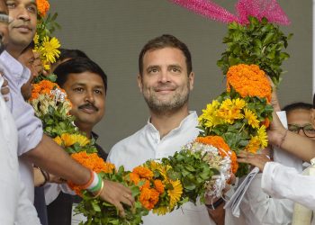 Silchar: Congress President Rahul Gandhi being garlanded at an election campaign rally ahead of the Lok Sabha polls, at Panchgram in Silchar, Assam, Tuesday, April 9, 2019. (PTI Photo)  (PTI4_9_2019_000052B)
