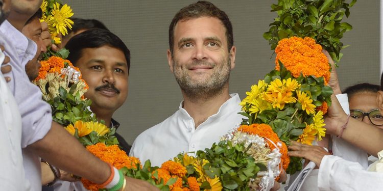Silchar: Congress President Rahul Gandhi being garlanded at an election campaign rally ahead of the Lok Sabha polls, at Panchgram in Silchar, Assam, Tuesday, April 9, 2019. (PTI Photo)  (PTI4_9_2019_000052B)