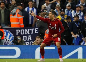 Roberto Firmino points to the fans in celebration after scoring the second goal for Liverpool against Porto, Tuesday