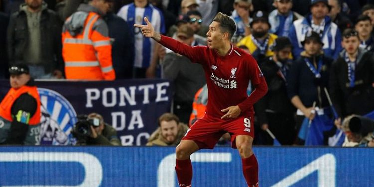 Roberto Firmino points to the fans in celebration after scoring the second goal for Liverpool against Porto, Tuesday