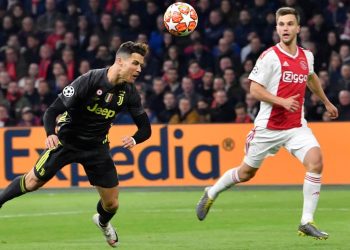 Cristiano Ronaldo of Juventus scores with a flying header as an Ajax Amsterdam defender watches him during the Champions League tie, Wednesday