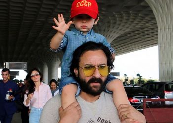 Taimur nonchalantly sat atop his father's shoulders, wearing a blue shirt, shorts and a red cap adding contrast to his look. (Image: IANS)