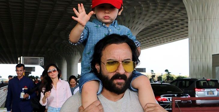 Taimur nonchalantly sat atop his father's shoulders, wearing a blue shirt, shorts and a red cap adding contrast to his look. (Image: IANS)