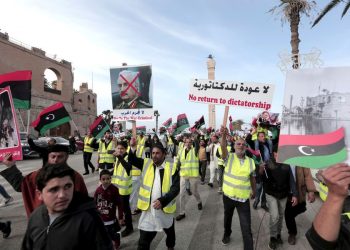 Protesters wear yellow vests at a protest in Tripoli, Libya, Friday, April 19, 2019, as they wave national flags and chant slogans against Libya's Field Marshal Khalifa Hifter, who is leading an offensive to take over the capital. (HAZEM AHMED/AP)