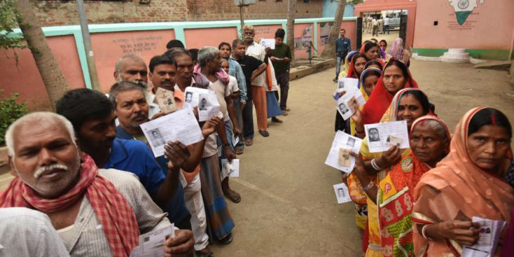 Voters stand in queue to cast their voters in Jharkhand