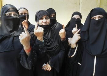 Burqa-clad women show their inked fingers after casting their votes at Moradabad in the third phase of the Lok Sabha polls, Saturday