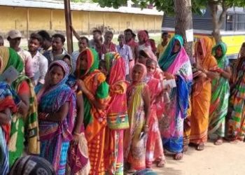 Women voters await their turn under sun at a booth in Purushottampur in Ganjam district, Thursday 	op photo