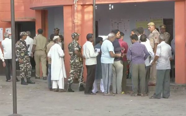 Polling in the presence of large number of security personnel in a booth in the Asansol Lok Sabha constituency