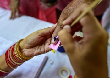 New Delhi: A polling officer puts indelible ink mark on the finger of a voter during the sixth phase of the 2019 Lok Sabha elections, at a modern polling station in Janakpuri, New Delhi, Sunday, May 12, 2019. (PTI Photo/Arun Sharma) (PTI5_12_2019_000121B)