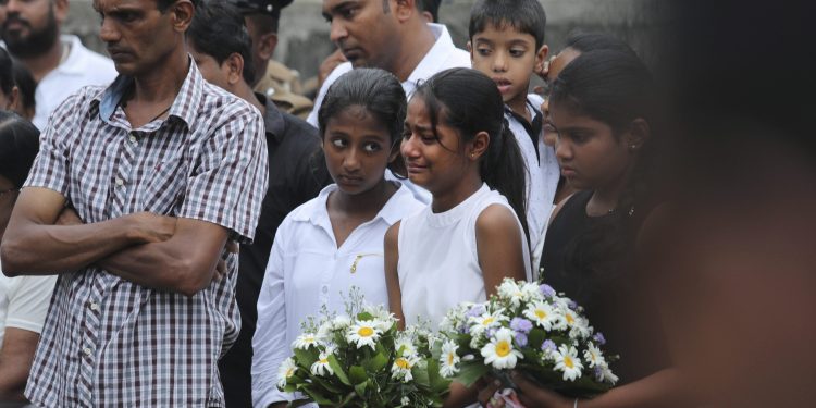 Negombo: Friends of Dhami Brandy, 13, who was killed during Easter Sunday's bomb blast at St. Sebastian Church, cries during funeral service in Negombo, Sri Lanka Thursday, April 25, 2019. The U.S. Embassy in Sri Lanka warned Thursday that places of worship could be targeted for militant attacks over the coming weekend, as police searched for more suspects in the Islamic State-claimed Easter suicide bombings that killed over 350 people. AP/PTI(AP4_25_2019_000164B)