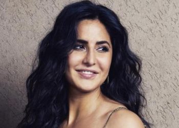 Katrina looks stylish in a short red dress with a denim shrug.