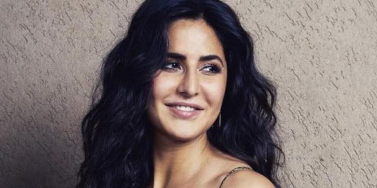 Katrina looks stylish in a short red dress with a denim shrug.