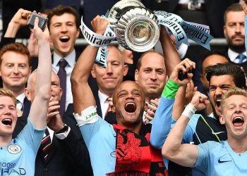 Manchester City players celebrate with the FA Cup after their win Saturday