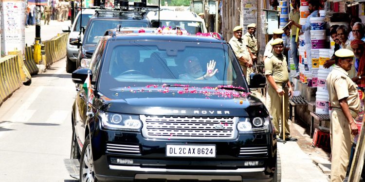 Narendra Modi waves to the crowd after arriving in Varanasi, Monday