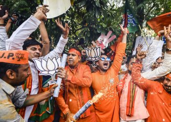 BJP workers celebrate their party's landslide win at the office of the saffron party in New Delhi