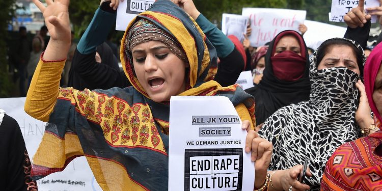 Srinagar: Protesters hold placards as they shout slogans during a protest against the alleged rape of a three-year-old girl by a local in Bandipora district of Jammu and Kashmir, in Srinagar, Monday, May 13, 2019. (PTI Photo/S. Irfan)(PTI5_13_2019_000082B)