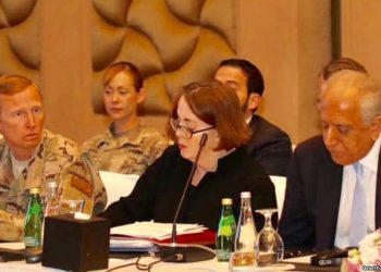 U.S. special envoy Zalmay Khalilzad (right) attends peace talks in Doha March 12.