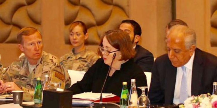 U.S. special envoy Zalmay Khalilzad (right) attends peace talks in Doha March 12.